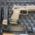 RIGHT SIDE OF PISTOL WITH 17 ROUND MAGAZINE INSTALLED AND TWO 21 ROUND SPARE MAGS