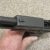 SLIDE PULLED BACK SHOWING ACTION AND BARREL ASSEMBLY