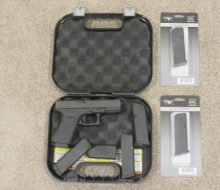 OPEN CASE SHOWING PISTOL AND 3 ORIGINAL AND 3 ADDITIONAL SPARE MAGS