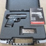 OPEN CASE SHOWING PISTOL AND SECOND MAGAZINE AND INSTRUCTION BOOK