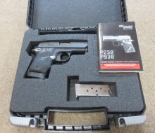 OPEN CASE SHOWING PISTOL AND SECOND MAGAZINE AND INSTRUCTION BOOK