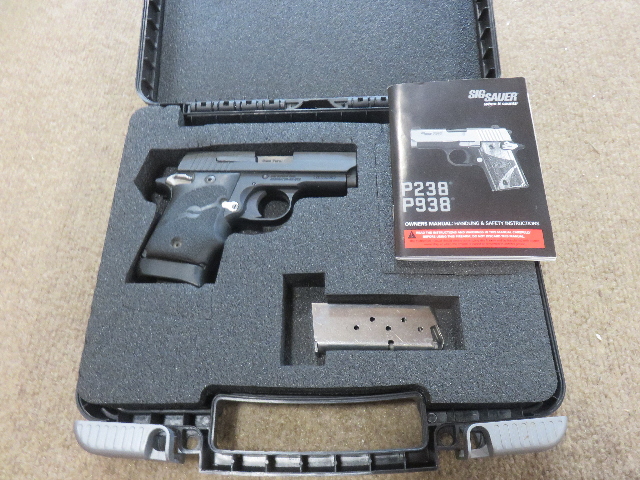 OPEN CASE SHOWING PISTOL AND SECOND MAGAZINE AND INSTRUCTION BOOK OPEN CASE SHOWING PISTOL AND SECOND MAGAZINE AND INSTRUCTION BOOK